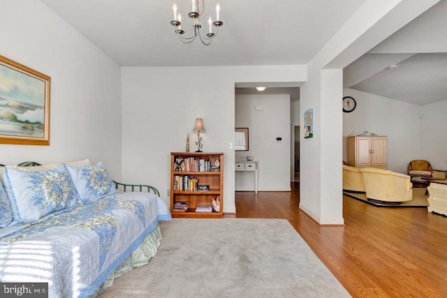 bedroom with an inviting chandelier and wood-type flooring