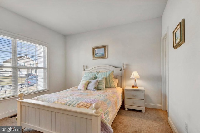 bedroom with light colored carpet