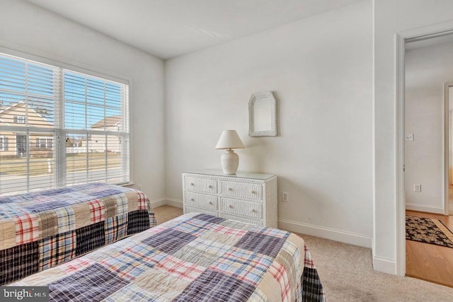 bedroom featuring light colored carpet