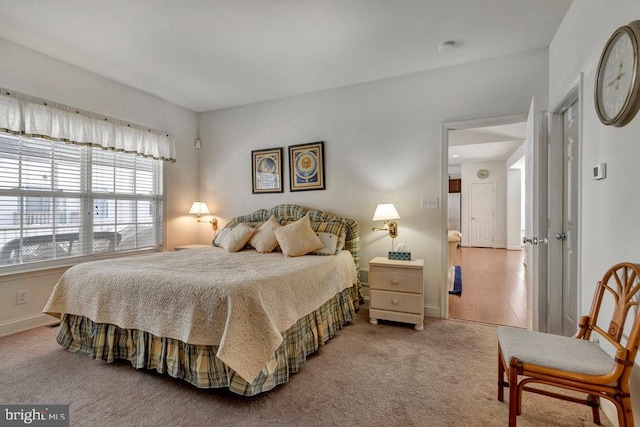 bedroom featuring light colored carpet