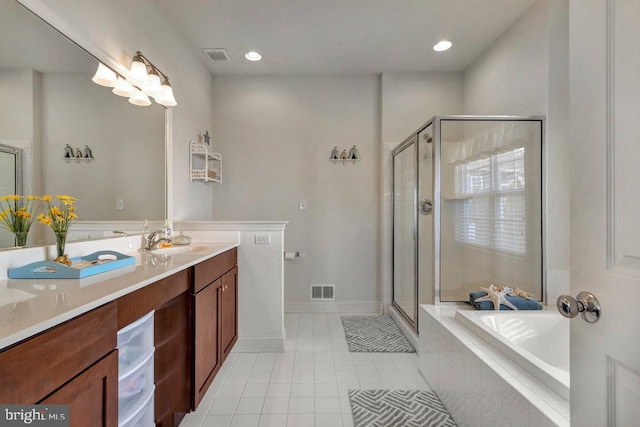 bathroom featuring shower with separate bathtub, vanity, and tile patterned floors