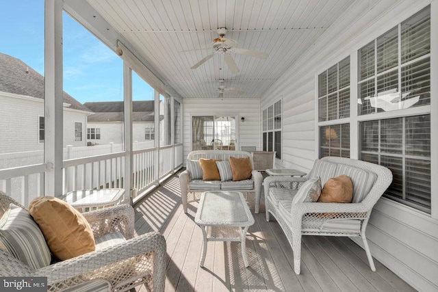 sunroom featuring ceiling fan