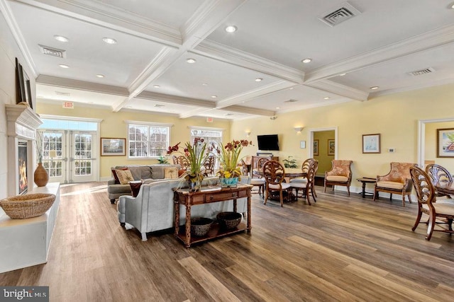 living room with french doors, coffered ceiling, wood-type flooring, ornamental molding, and beamed ceiling