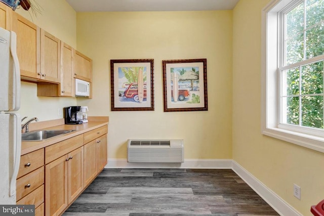 kitchen featuring dark wood-type flooring, light brown cabinetry, sink, a wall mounted AC, and white appliances