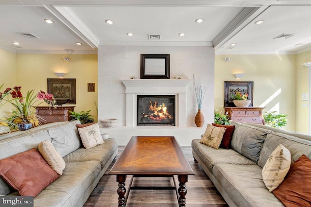 living room featuring ornamental molding and wood-type flooring