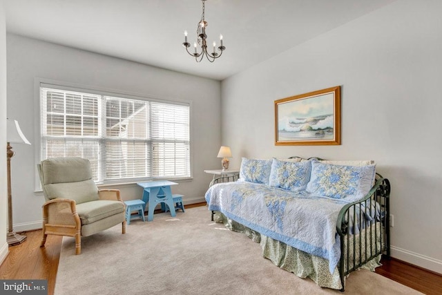 bedroom featuring a notable chandelier and hardwood / wood-style floors