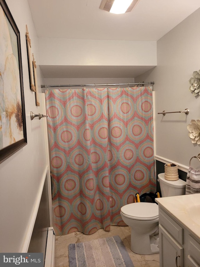 bathroom featuring vanity, toilet, and baseboard heating