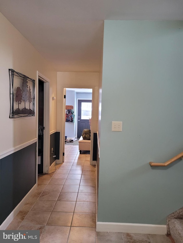 hall featuring light tile patterned flooring