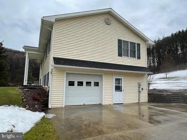 view of side of property with a garage