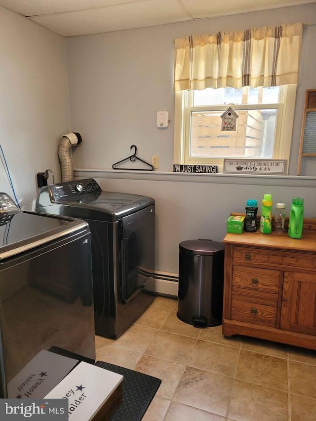 clothes washing area with independent washer and dryer and baseboard heating