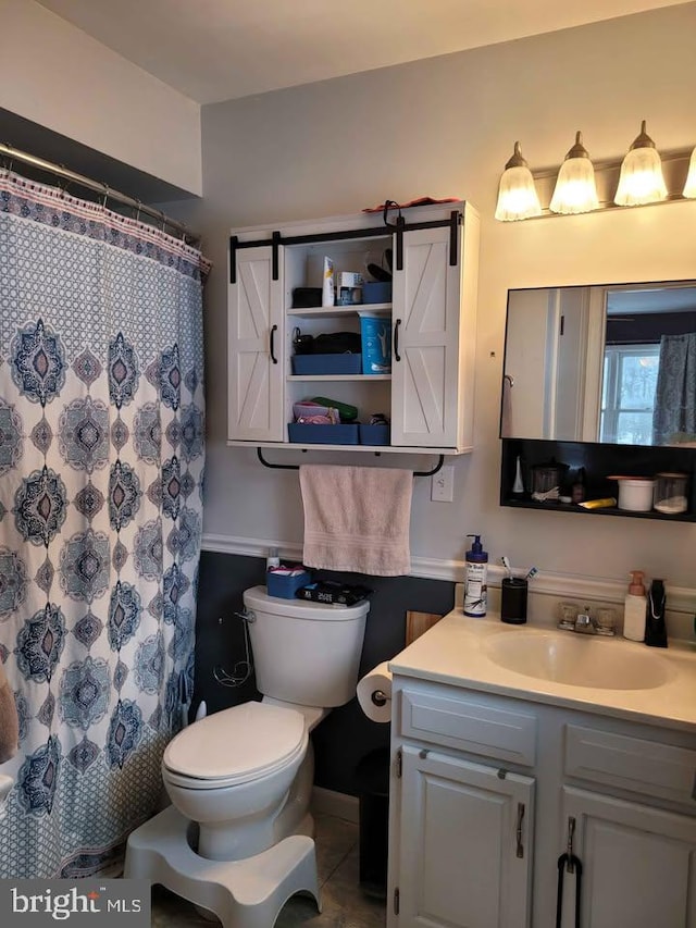 bathroom featuring vanity, tile patterned floors, toilet, and walk in shower