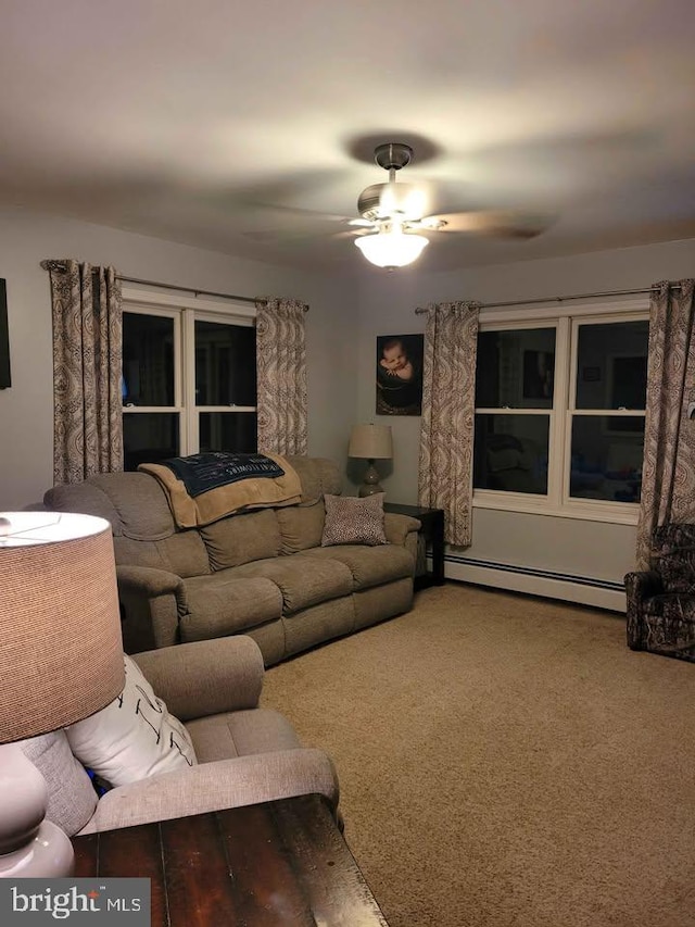 carpeted living room with ceiling fan and baseboard heating