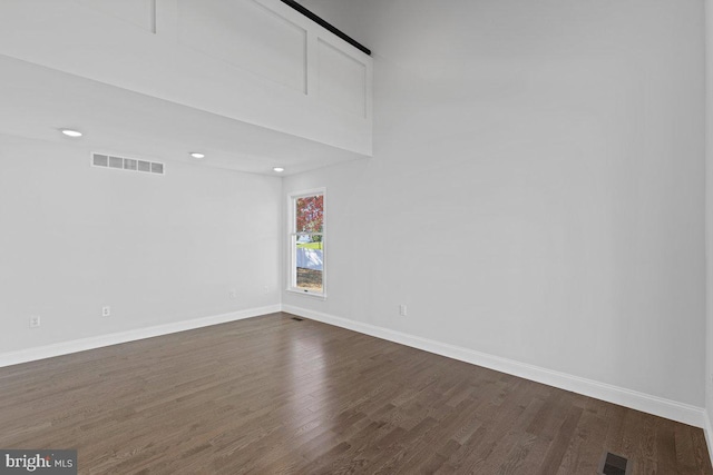 spare room with dark hardwood / wood-style floors