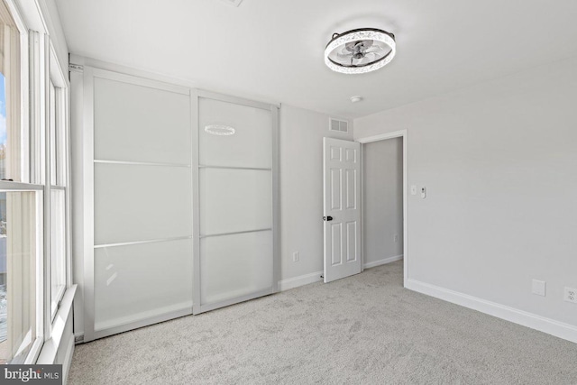 unfurnished bedroom with light carpet