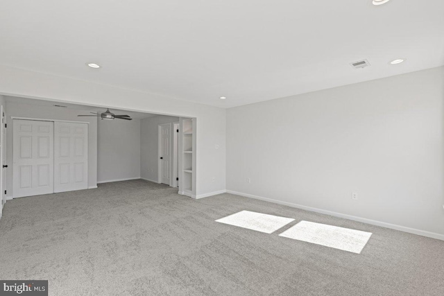 unfurnished bedroom with light carpet and a closet