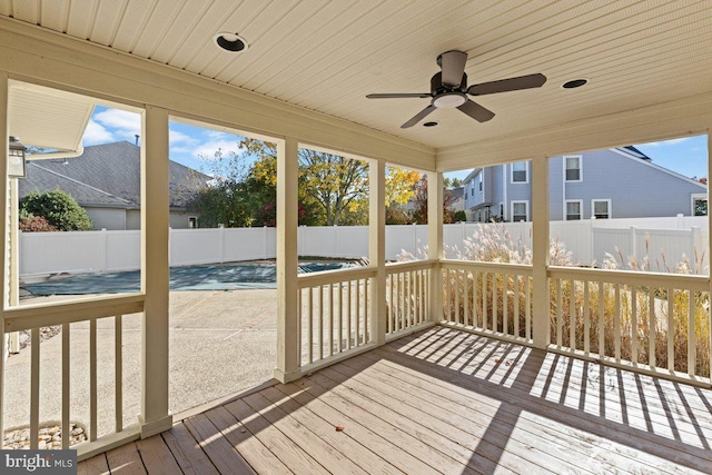 unfurnished sunroom with wood ceiling and ceiling fan