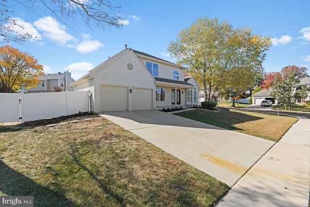 view of front of home with a garage and a front lawn