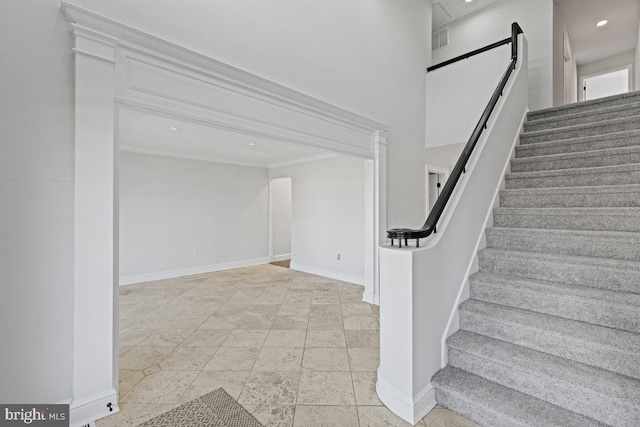 stairs featuring crown molding