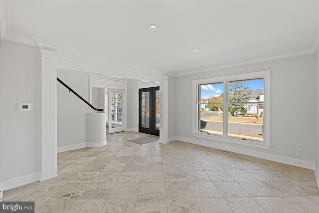 foyer with crown molding and french doors