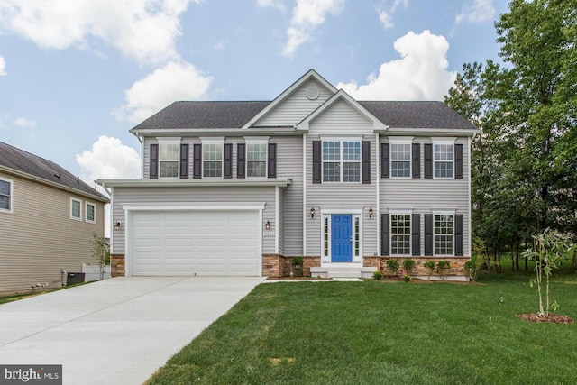 view of front of property featuring a garage and a front yard