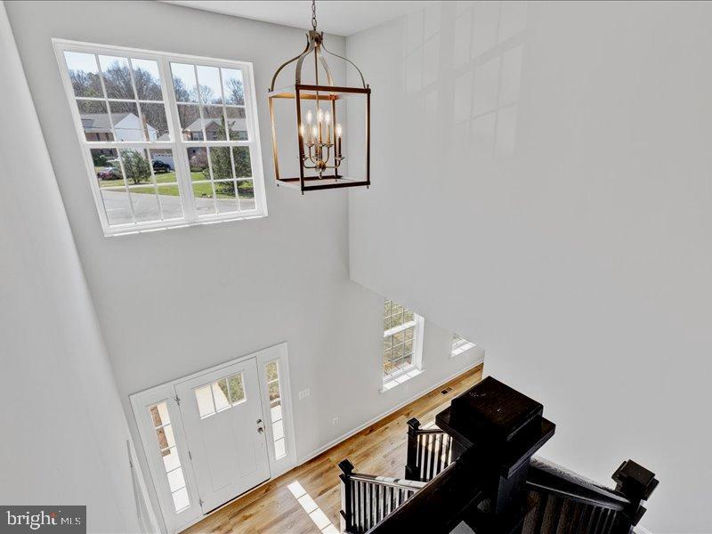 foyer entrance featuring an inviting chandelier and light wood-type flooring