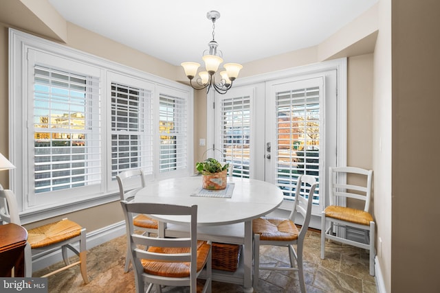 dining area featuring french doors and a notable chandelier