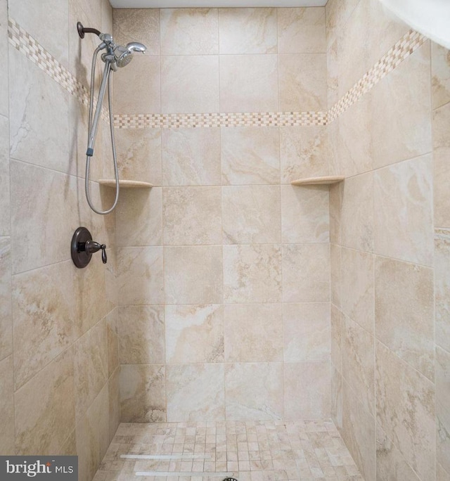 bathroom with tiled shower