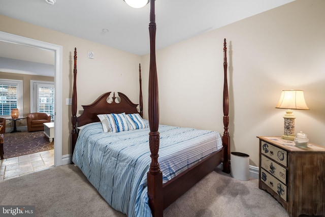 bedroom featuring light carpet