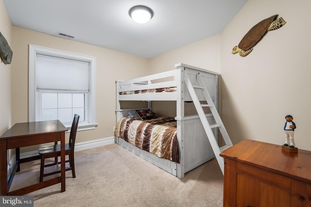 bedroom featuring light carpet