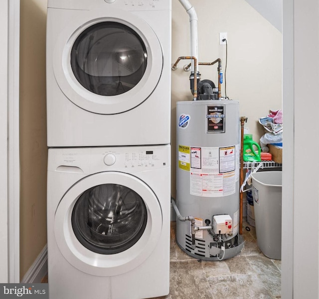 laundry area with water heater and stacked washer and clothes dryer