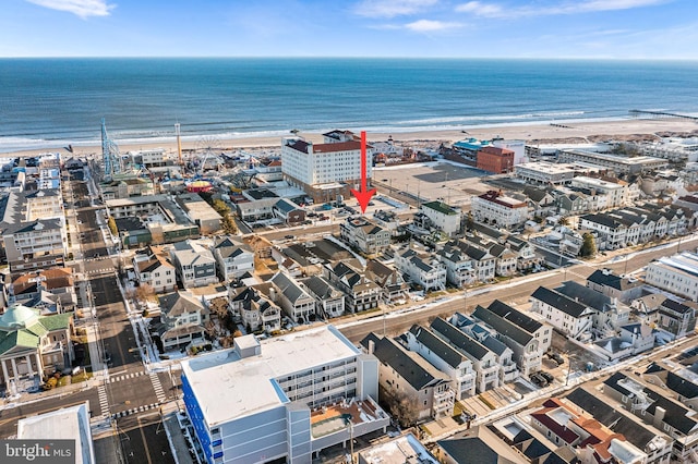 birds eye view of property with a water view and a view of the beach