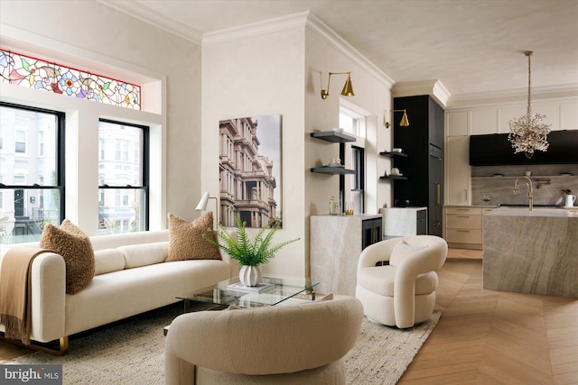 living room with sink, a notable chandelier, and ornamental molding