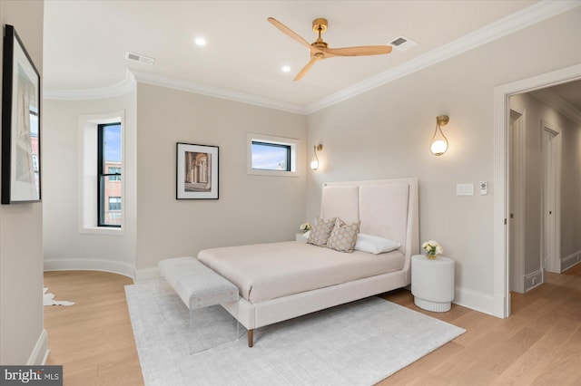 bedroom featuring crown molding, light hardwood / wood-style flooring, and ceiling fan