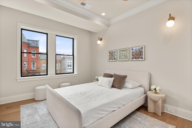 bedroom with crown molding and wood-type flooring