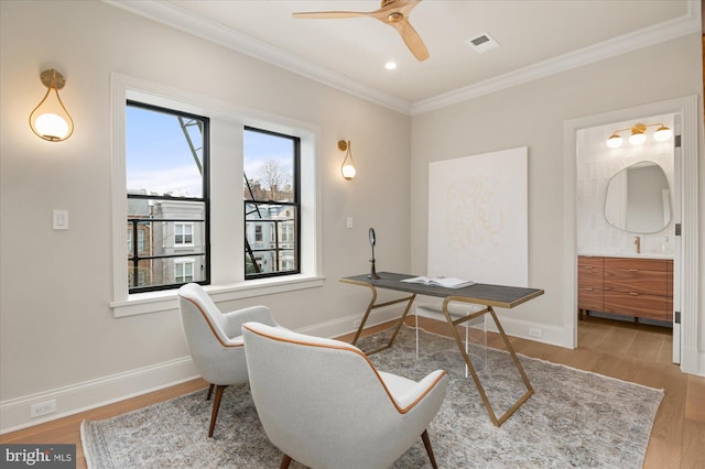 office featuring crown molding, ceiling fan, and light wood-type flooring