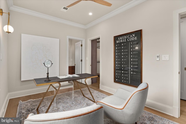 office space featuring wood-type flooring, ceiling fan, and crown molding