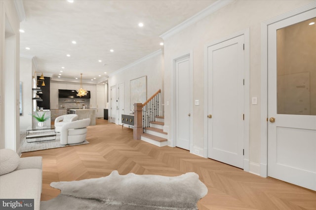 living room with ornamental molding and light parquet floors