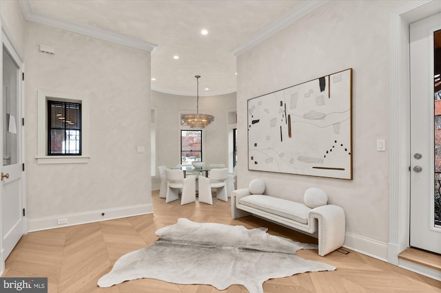 living area featuring light parquet floors, ornamental molding, and a chandelier