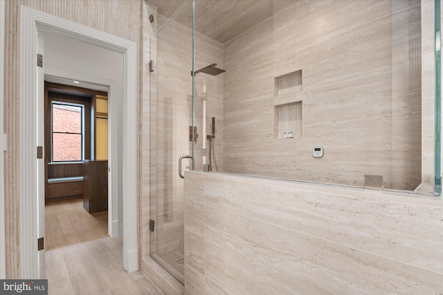 bathroom featuring hardwood / wood-style flooring and a shower with shower door