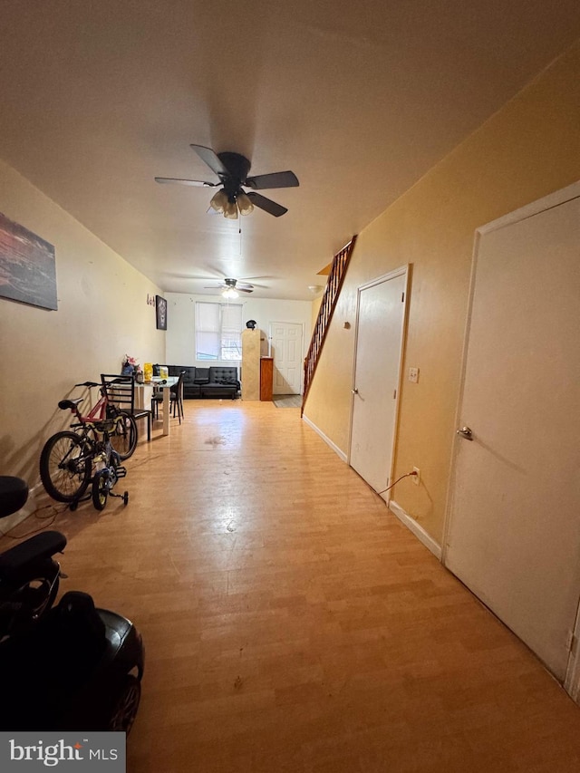 additional living space with light hardwood / wood-style floors and ceiling fan