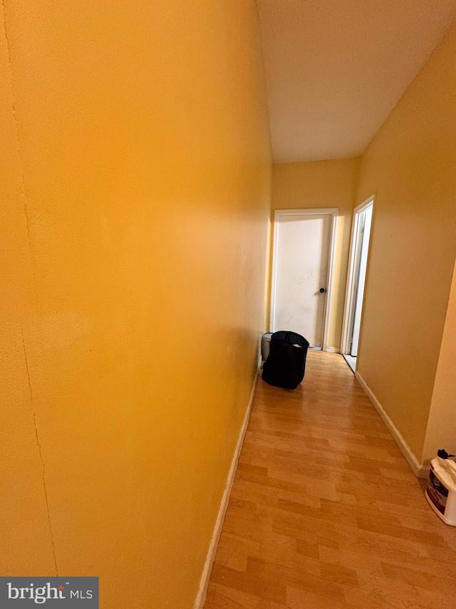 hallway with wood-type flooring