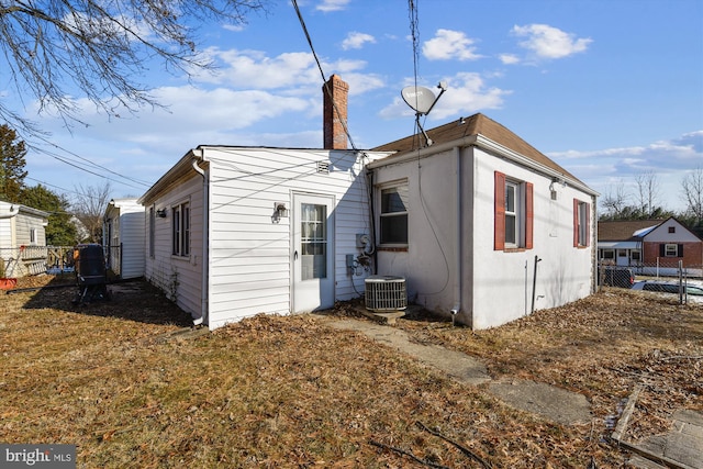 rear view of property with cooling unit