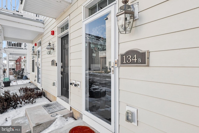 view of snow covered property entrance