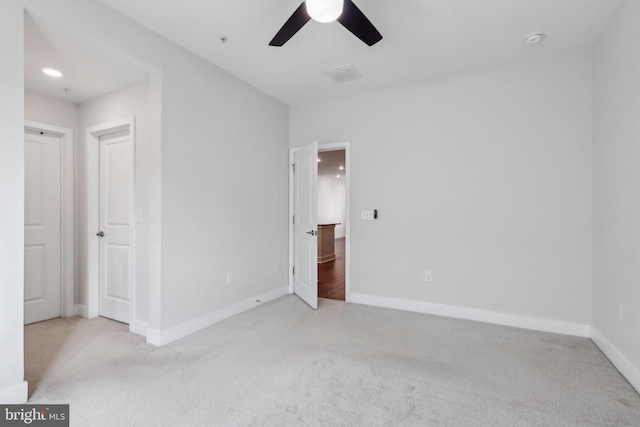 unfurnished bedroom with ceiling fan and light carpet