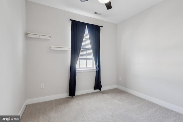 unfurnished room with ceiling fan and light colored carpet