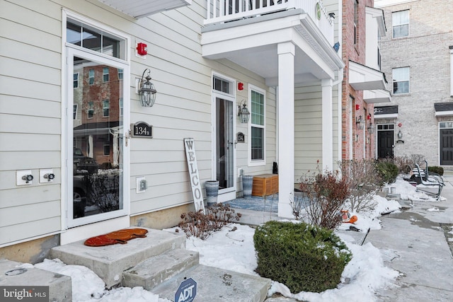 view of snow covered property entrance