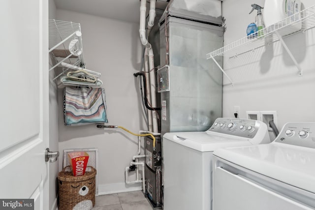 washroom with washer and dryer and light tile patterned floors