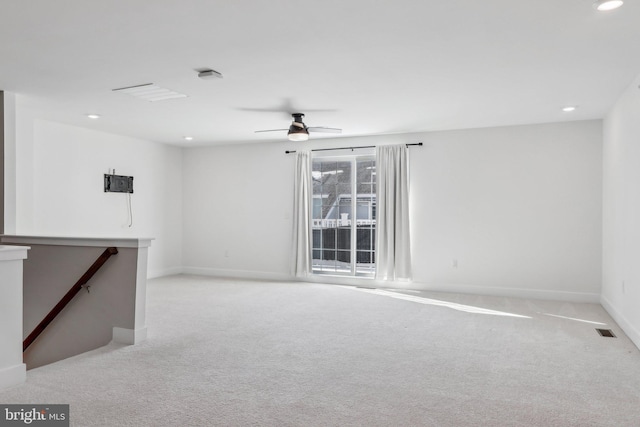 spare room featuring ceiling fan and light colored carpet