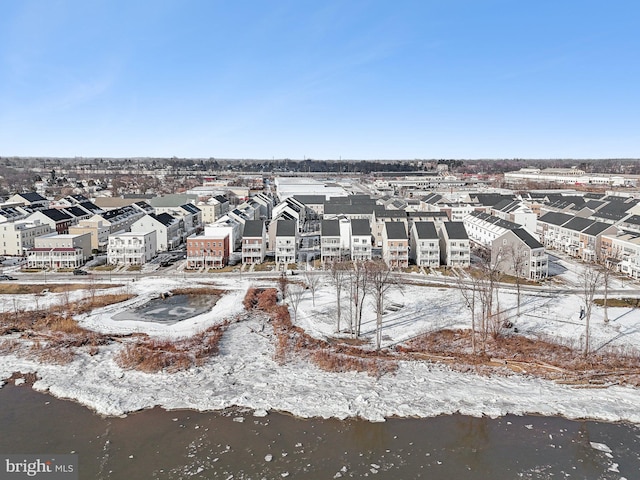 snowy aerial view featuring a water view