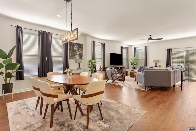 dining room with ceiling fan and wood-type flooring